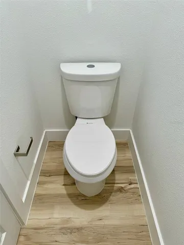 a white toilet sitting next to a white door