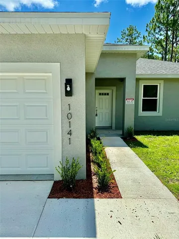 a view of a house with a small yard