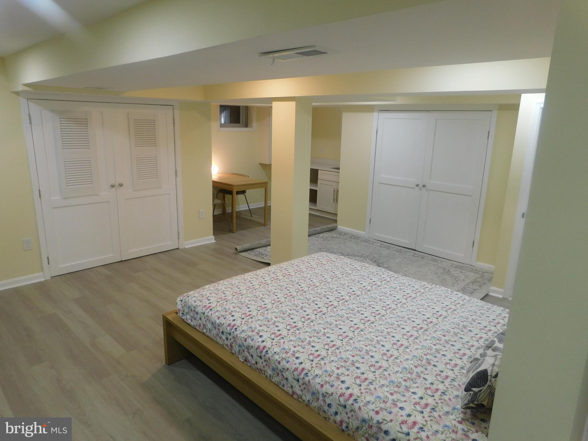 5600 11th Street North Arlington, VA 22205 - Photo 14 of 34 a spacious bedroom with a bed and wooden floor
