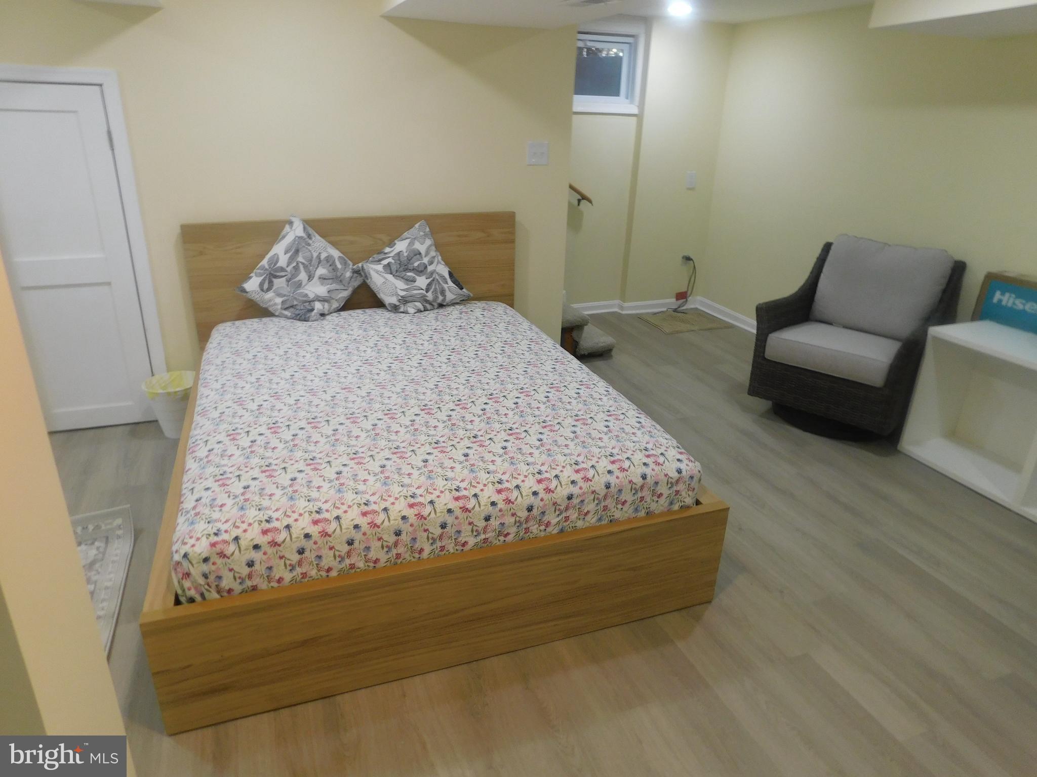 5600 11th Street North Arlington, VA 22205 - Photo 15 of 34 a bed sitting in a bedroom next to a couch