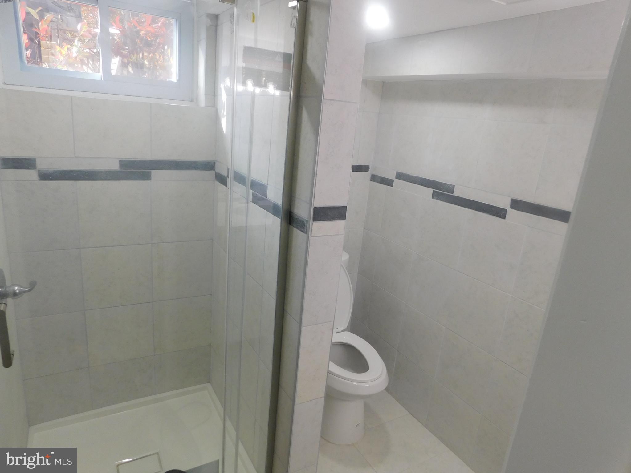 5600 11th Street North Arlington, VA 22205 - Photo 26 of 34 a bathroom with a white toilet and shower