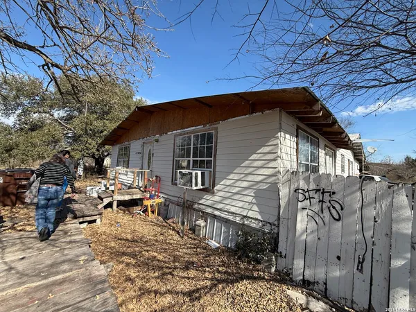 a backyard of a house with table and chairs