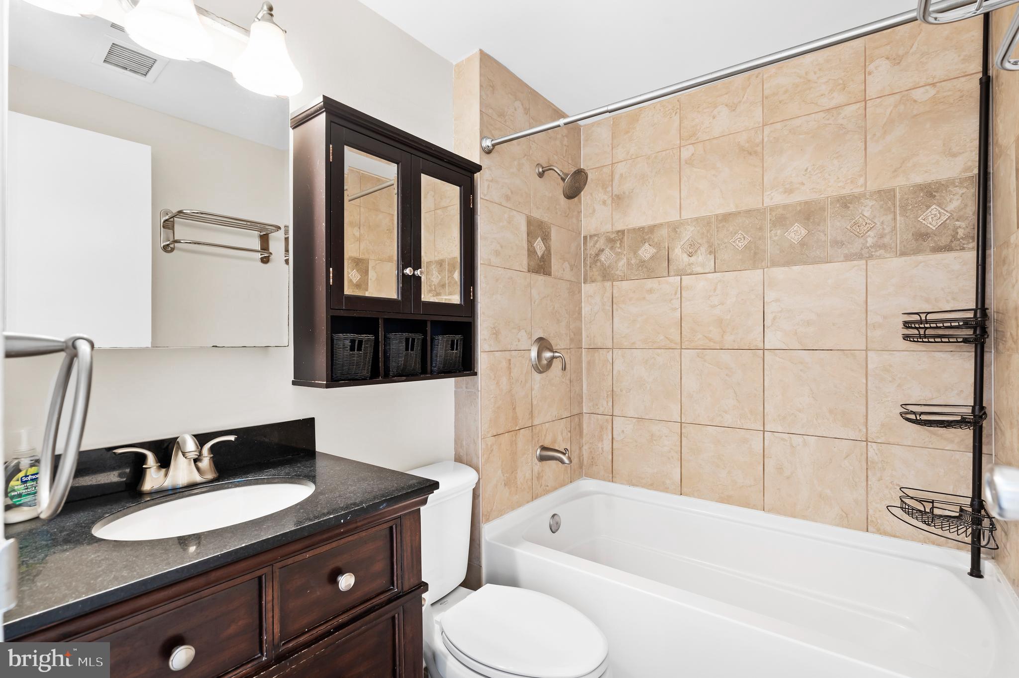 136 North Bread Street, Unit 130 Philadelphia, PA 19106 - Photo 11 of 31 a bathroom with a granite countertop sink toilet bathtub and shower