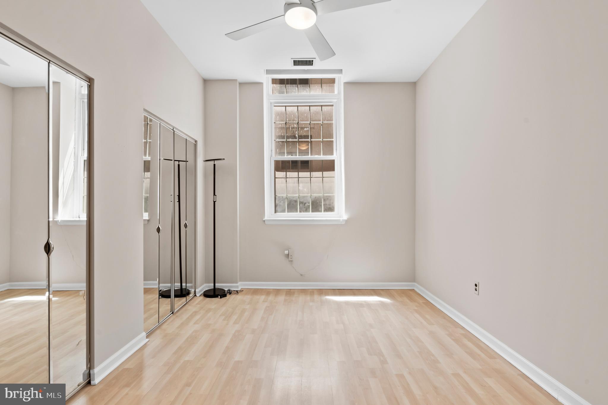 136 North Bread Street, Unit 130 Philadelphia, PA 19106 - Photo 13 of 31 an empty room with wooden floor cabinet and windows