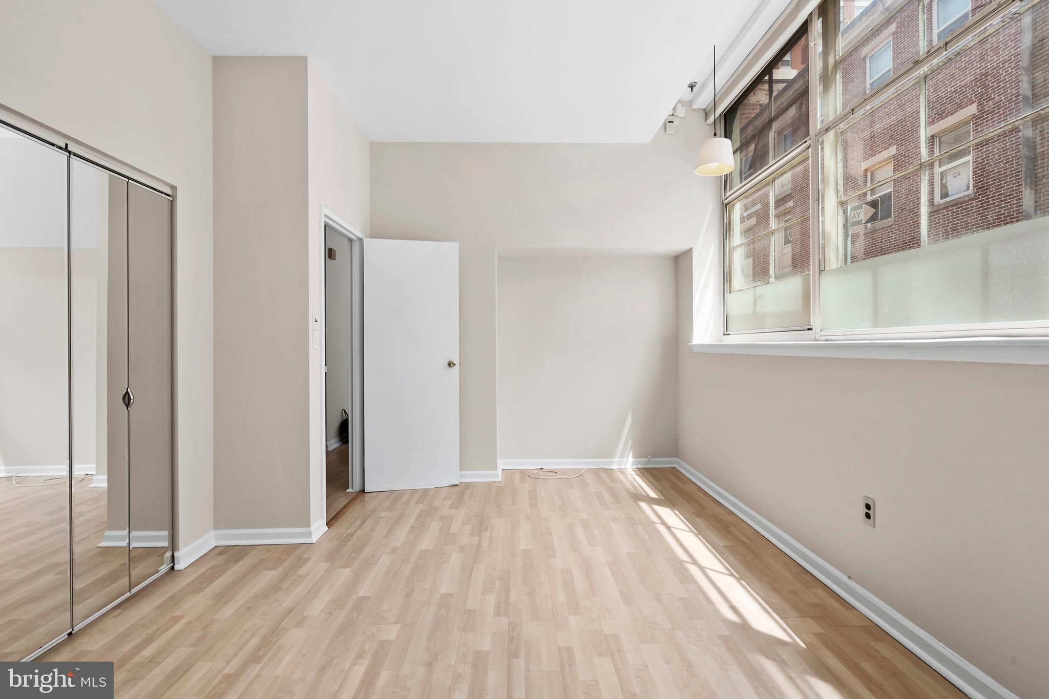 136 North Bread Street, Unit 130 Philadelphia, PA 19106 - Photo 18 of 31 a view of a room with wooden floor and a window