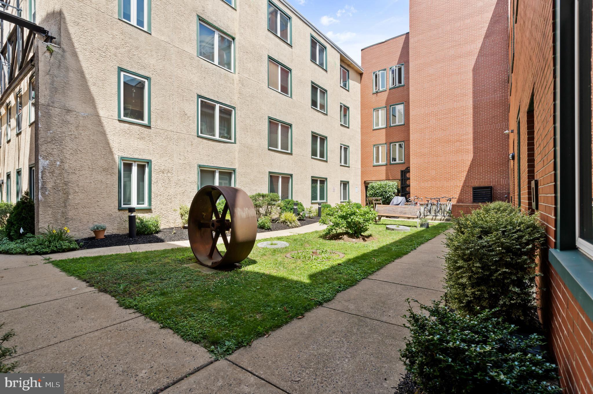 136 North Bread Street, Unit 130 Philadelphia, PA 19106 - Photo 24 of 31 a view of a building next to a yard