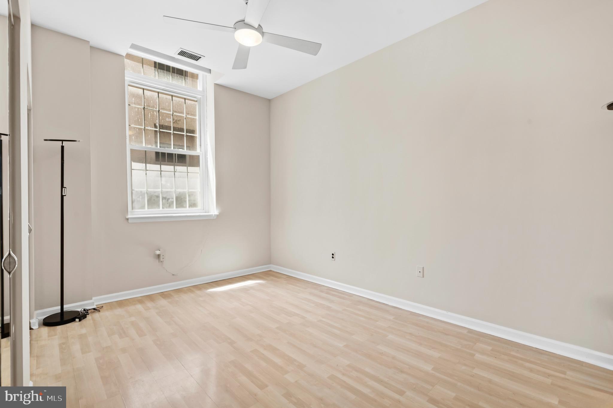 136 North Bread Street, Unit 130 Philadelphia, PA 19106 - Photo 5 of 31 wooden floor in an empty room with a window