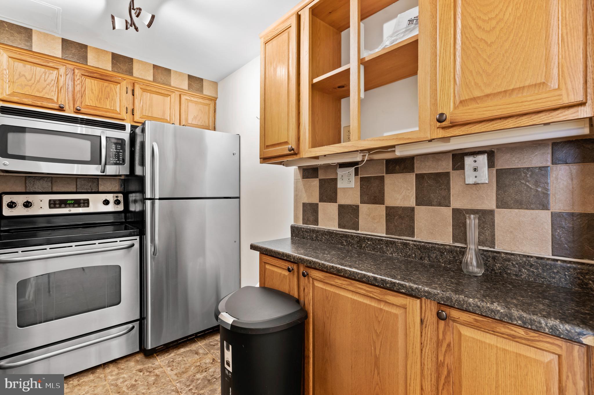136 North Bread Street, Unit 130 Philadelphia, PA 19106 - Photo 10 of 31 a kitchen with stainless steel appliances granite countertop a refrigerator a stove and a sink