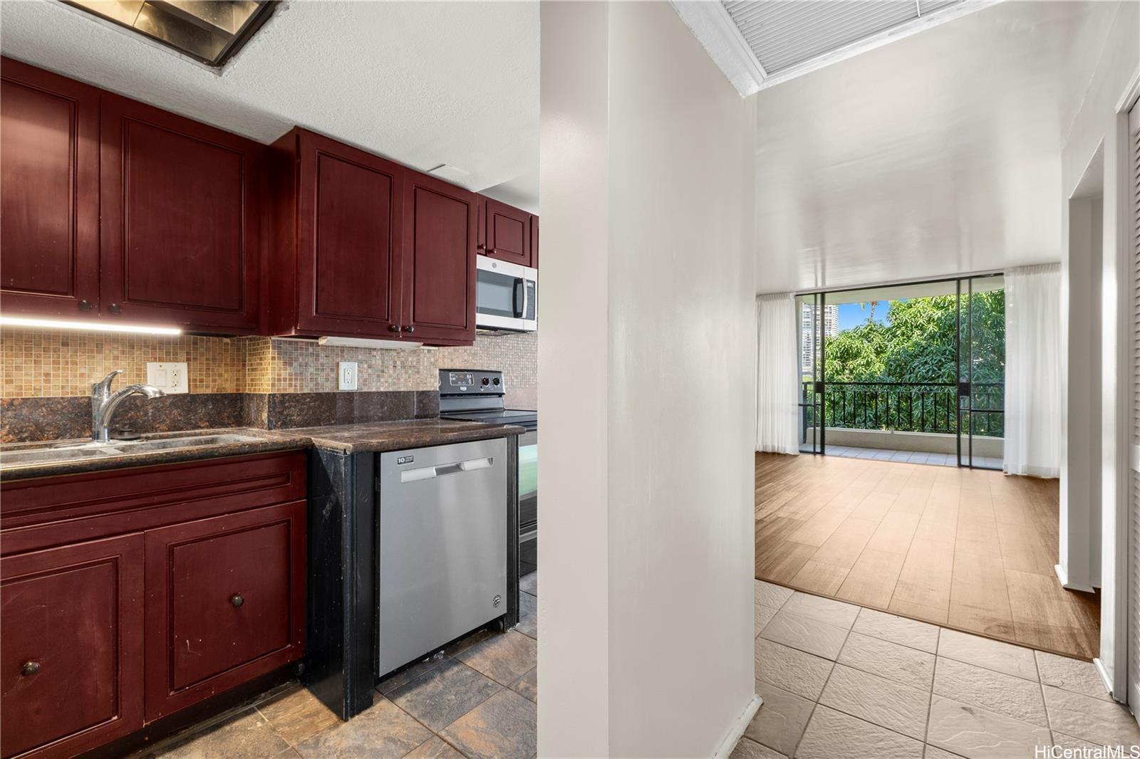440 Seaside Avenue, Unit 404 Honolulu, HI 96815 - Photo 11 of 21 a kitchen with granite countertop a stove a sink and a cabinets