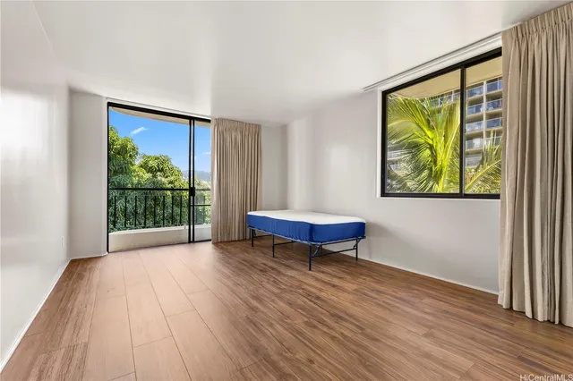 a view of a room with wooden floor and furniture