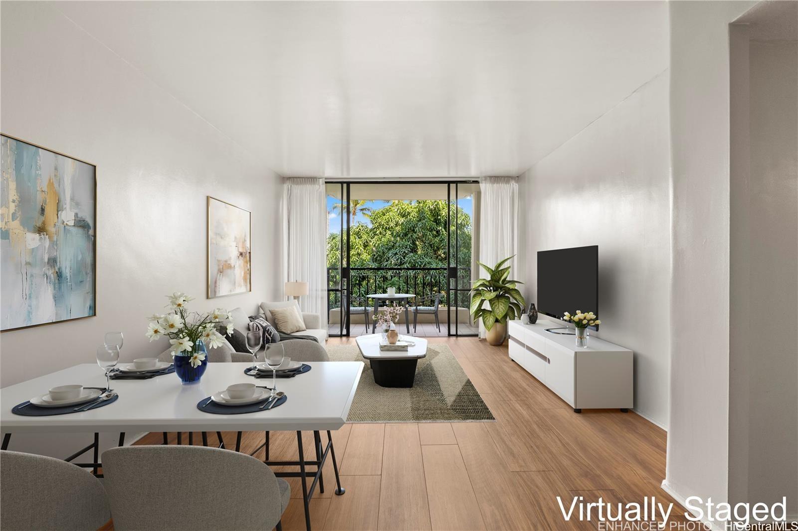440 Seaside Avenue, Unit 404 Honolulu, HI 96815 - Photo 2 of 21 a living room with furniture and a flat screen tv