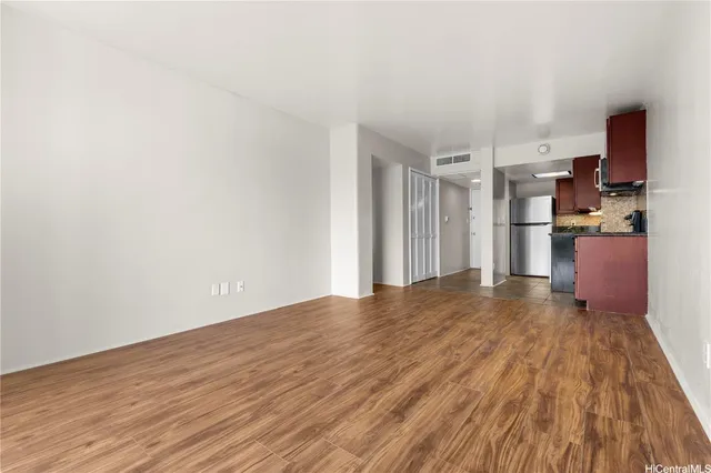 a view of kitchen with refrigerator microwave and stove