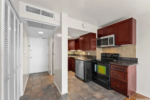 a kitchen with stainless steel appliances granite countertop a stove and a refrigerator