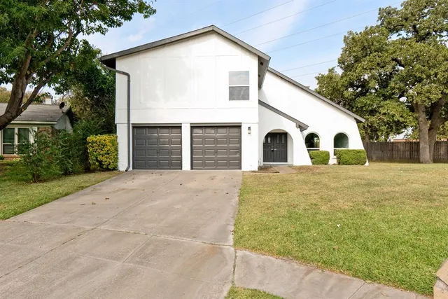 a view of a white house with a outdoor space
