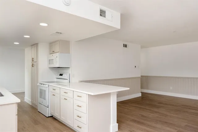 a kitchen with white cabinets