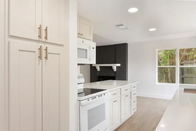 a kitchen with stainless steel appliances a stove a sink and a refrigerator