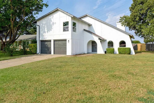 a view of a white house with a yard