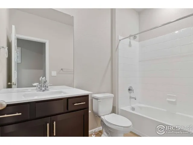 a bathroom with a sink a toilet a mirror and shower