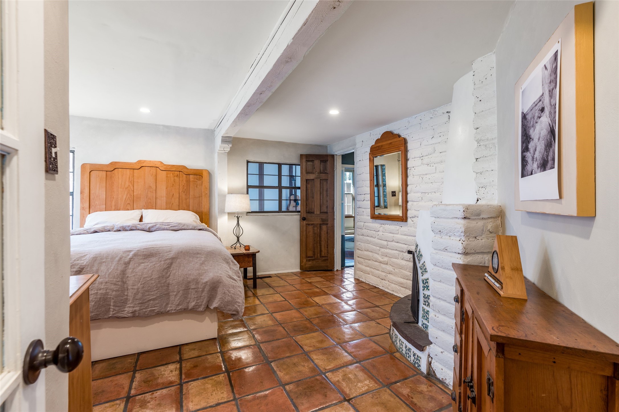 1402 Bishops Lodge Road, Unit A Santa Fe, NM 87506 - Photo 20 of 40 Primary Bedroom w/ Kiva Fireplace