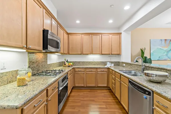 a kitchen with a sink stove top oven and cabinets