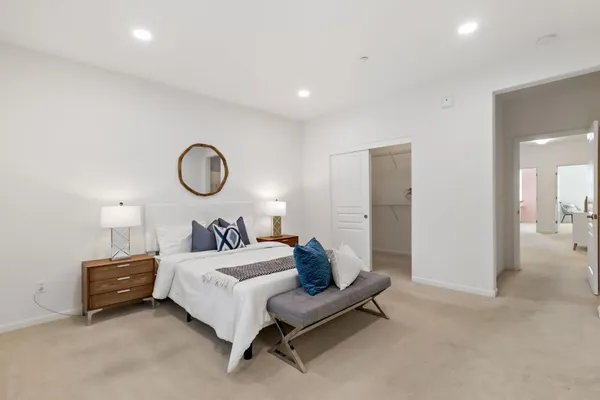 a bathroom with a tub a double vanity sink a window a mirror and vanity