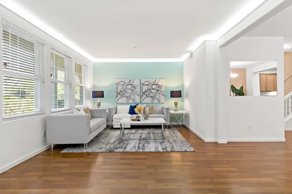 a living room with furniture and wooden floor
