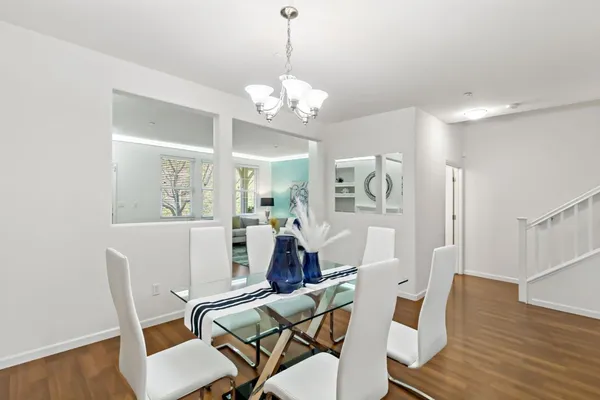 a workspace with wooden floor and a chandelier