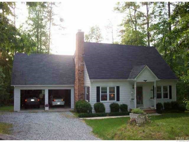 5815 Russell Road Durham, NC 27712 - Photo 1 of 1 a front view of a house with garden