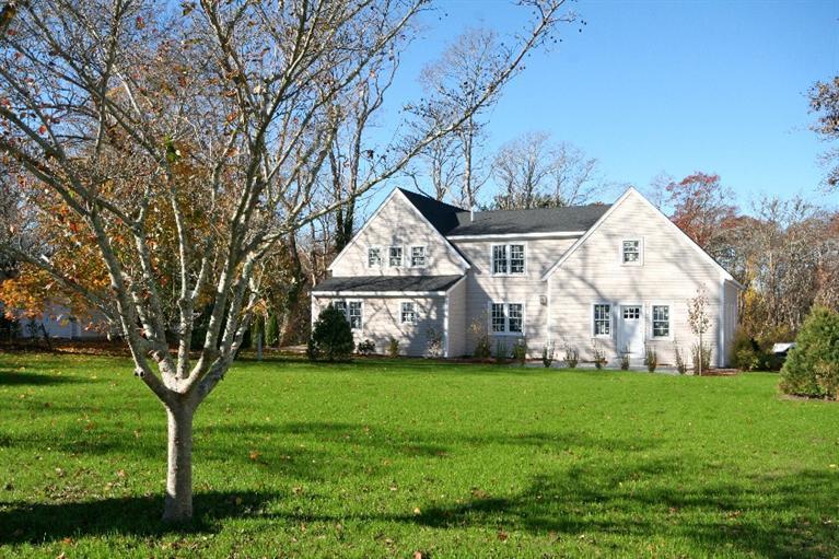 80 County Road, Unit 3 North Falmouth, MA 02556 - Photo 2 of 17 a front view of a house with a yard