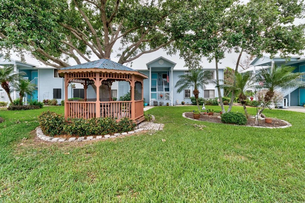 9637 Riverside Drive, Unit 3 Sebastian, FL 32958 - Photo 31 of 36 front view of a house with a yard