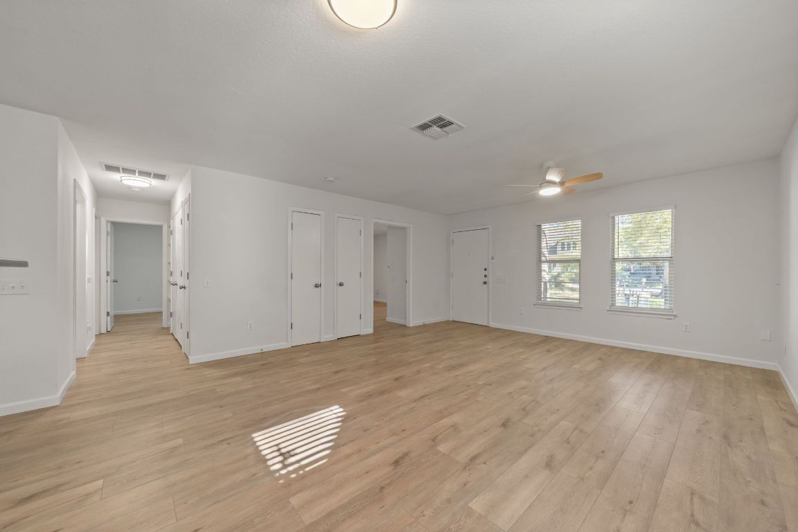 1804 Singleton Avenue Austin, TX 78702 - Photo 11 of 36 an empty room with wooden floor and windows