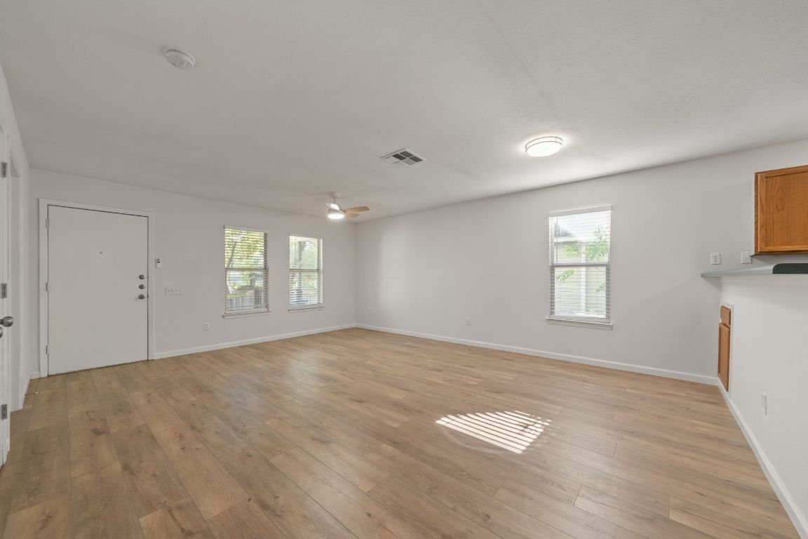 1804 Singleton Avenue Austin, TX 78702 - Photo 12 of 36 a view of empty room with wooden floor and fan