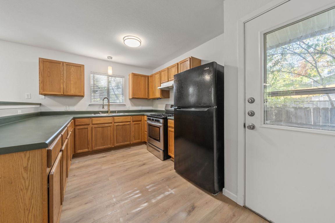 1804 Singleton Avenue Austin, TX 78702 - Photo 13 of 36 a kitchen with cabinets a sink and stainless steel appliances