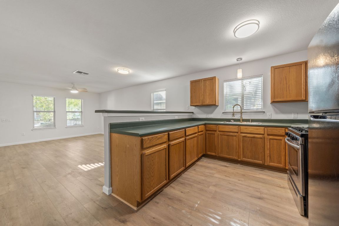 1804 Singleton Avenue Austin, TX 78702 - Photo 14 of 36 a kitchen with stainless steel appliances granite countertop a sink and a stove top oven
