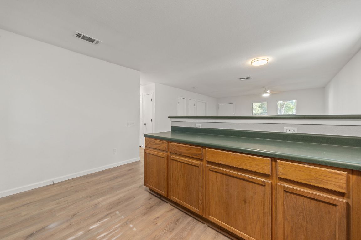 1804 Singleton Avenue Austin, TX 78702 - Photo 16 of 36 a view of a kitchen with wooden floor and cabinets