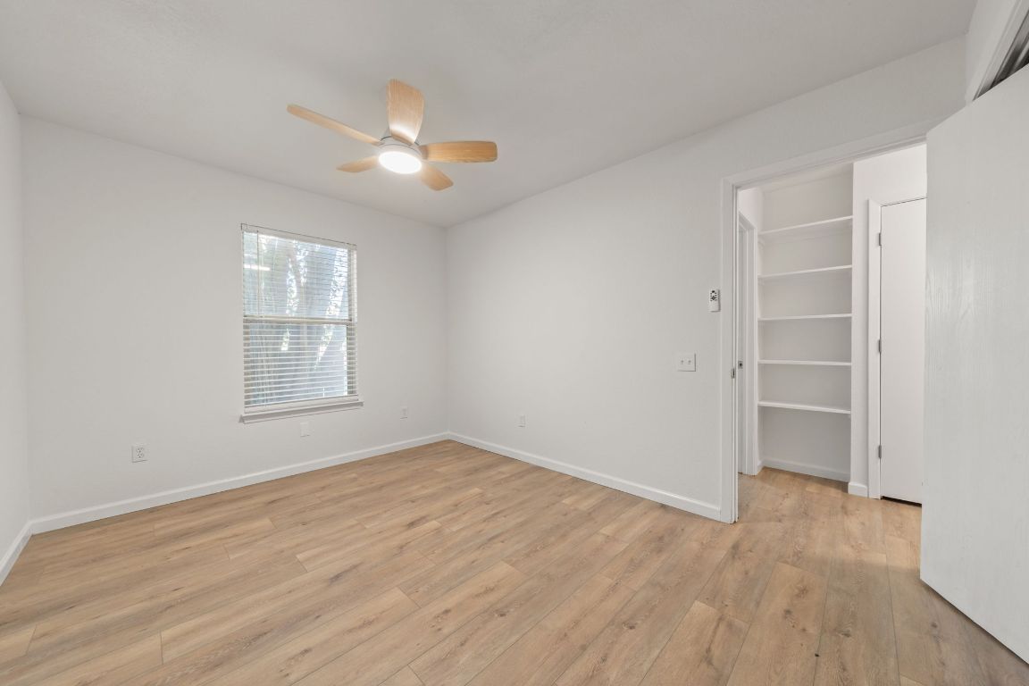 1804 Singleton Avenue Austin, TX 78702 - Photo 21 of 36 an empty room with wooden floor closet and windows