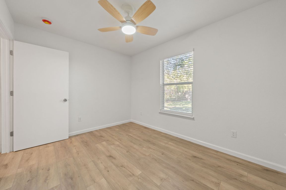 1804 Singleton Avenue Austin, TX 78702 - Photo 22 of 36 an empty room with a window and a fan