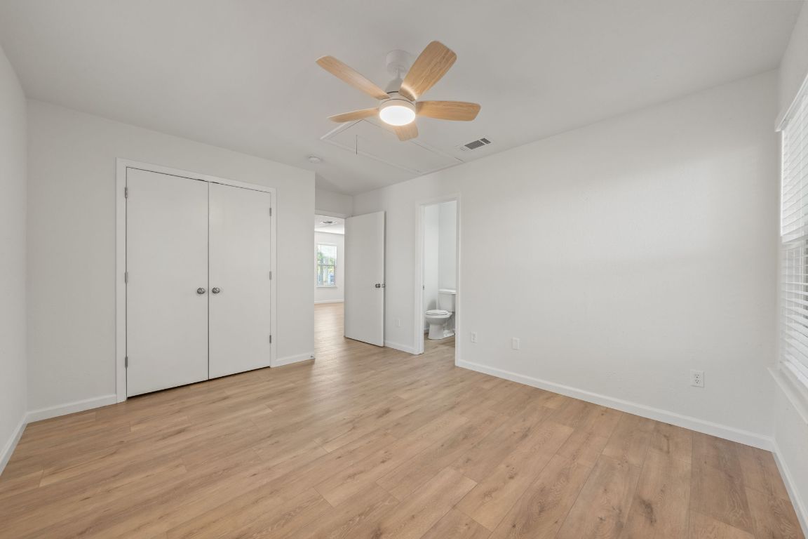 1804 Singleton Avenue Austin, TX 78702 - Photo 28 of 36 an empty room with wooden floor and a ceiling fan