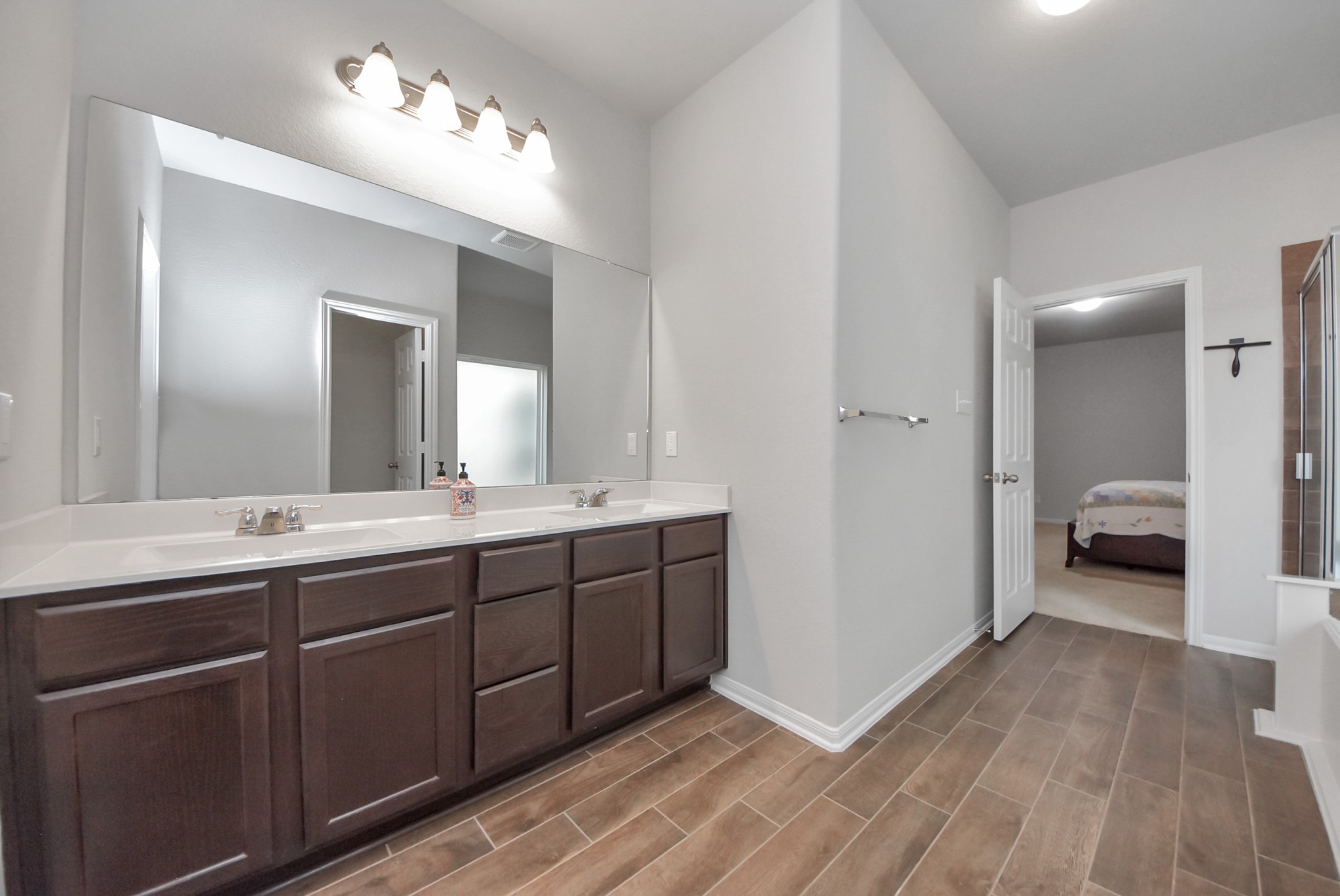 4239 Wyanngate Drive Spring, TX 77373 - Photo 20 of 36 a spacious bathroom with a double vanity sink and a mirror