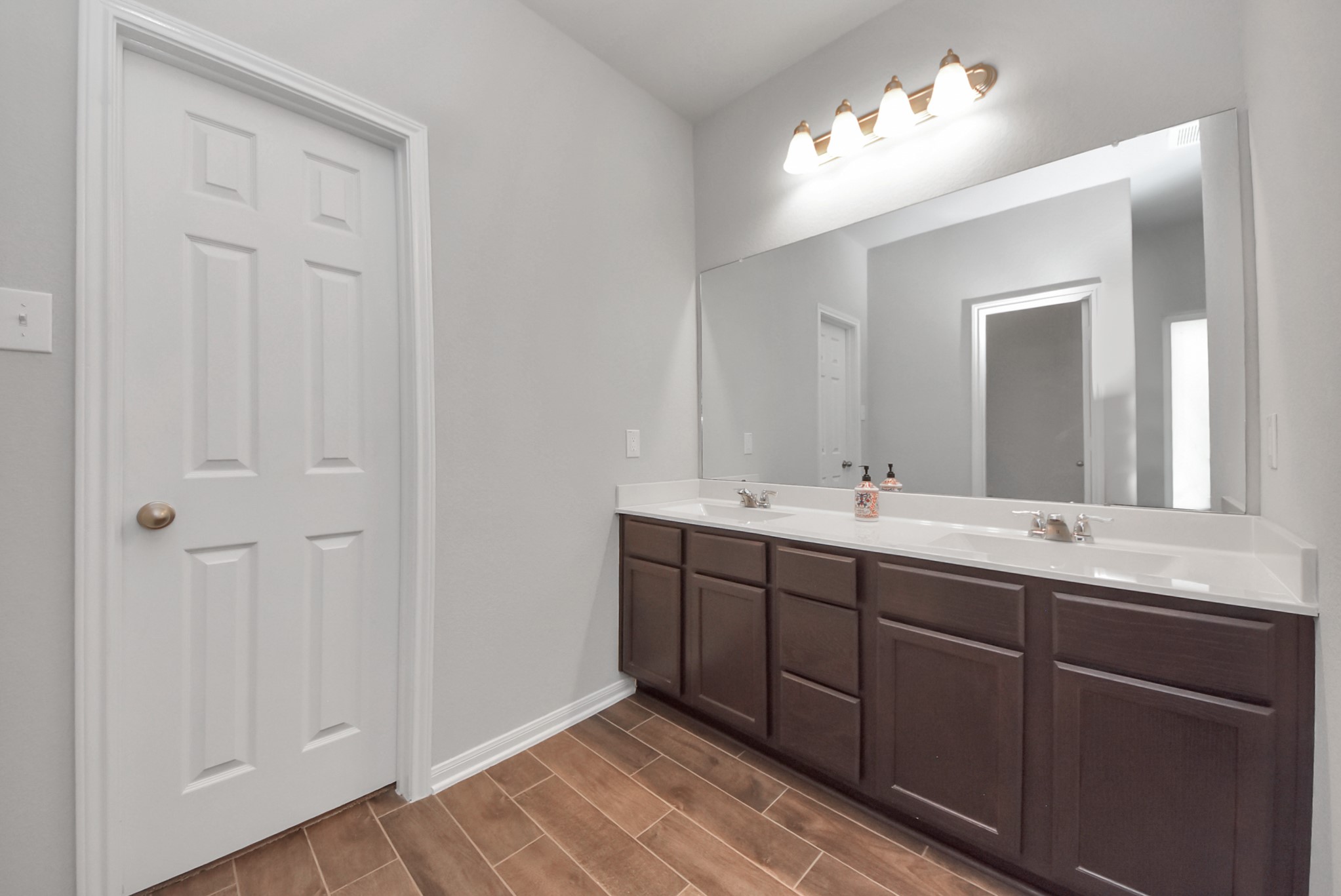 4239 Wyanngate Drive Spring, TX 77373 - Photo 29 of 36 a bathroom with a double vanity sink and a mirror
