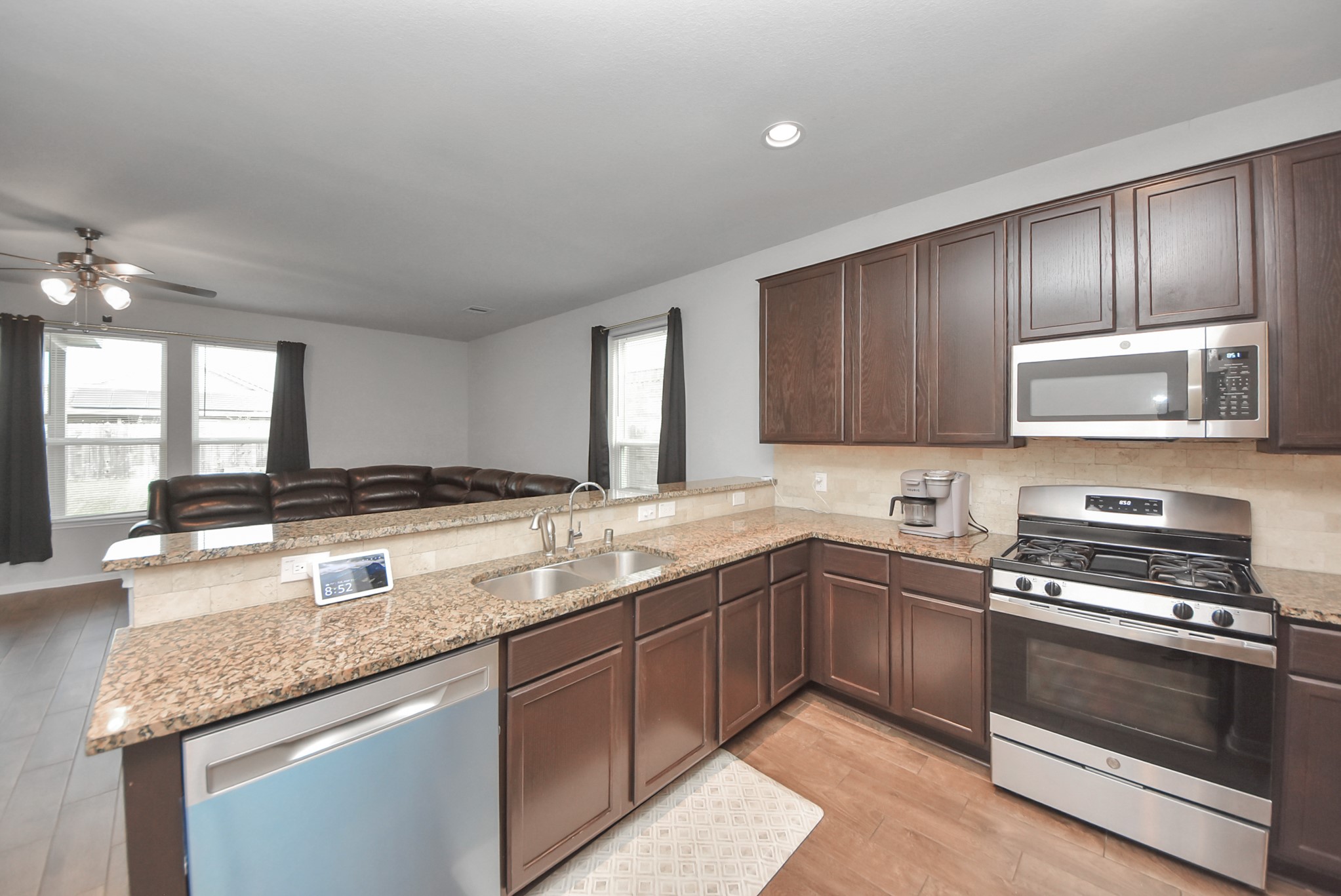 4239 Wyanngate Drive Spring, TX 77373 - Photo 7 of 36 a kitchen with granite countertop stainless steel appliances a sink stove top oven and cabinets