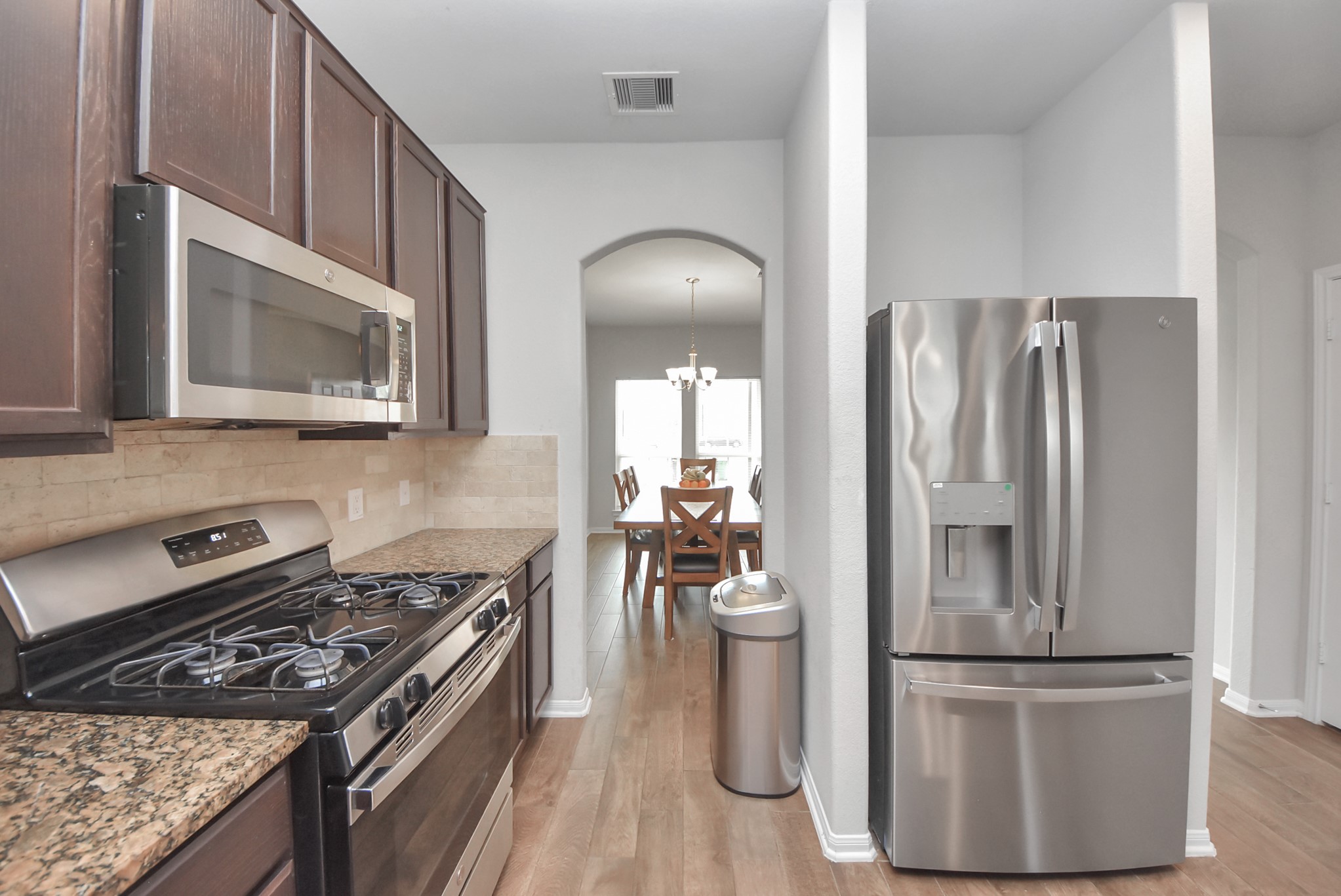 4239 Wyanngate Drive Spring, TX 77373 - Photo 8 of 36 a kitchen with a refrigerator and a stove
