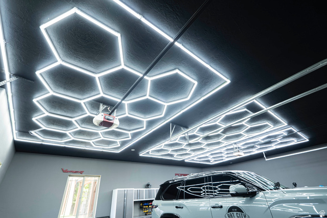 687 South 2080th Street East Springville, UT 84663 - Photo 65 of 149 Garage space featuring a dark ceiling with hexagonal LED lighting, light gray walls, and built-in gray storage cabinetry