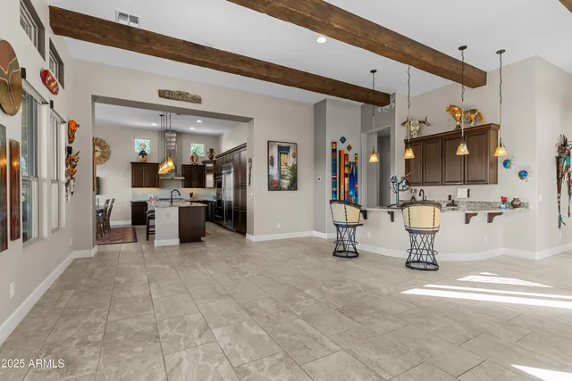 a kitchen with kitchen island a counter top space appliances and a sink