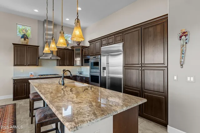 a kitchen with stainless steel appliances granite countertop a sink and cabinets