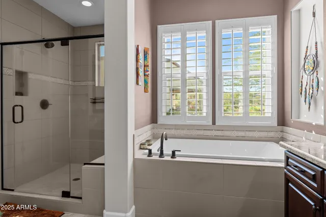a bathroom with a granite countertop sink a toilet and shower