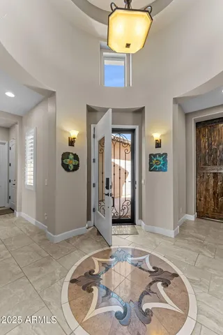 a living room with furniture a flat screen tv and floor to ceiling window