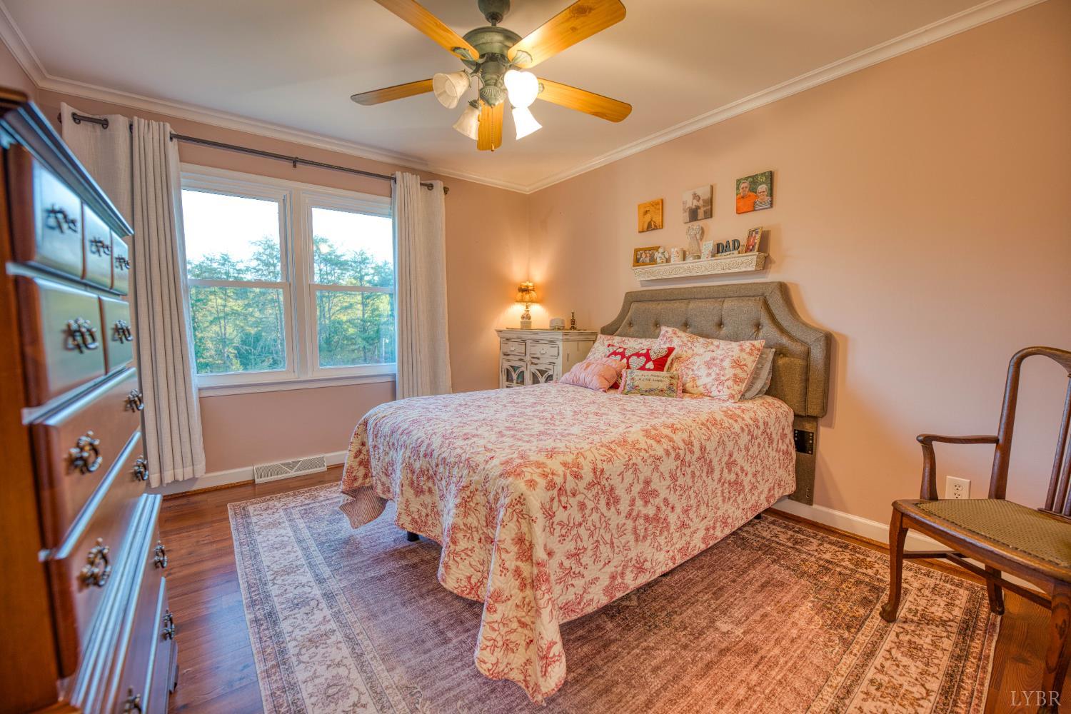 2287 Johnson Creek Road Evington, VA 24550 - Photo 19 of 70 a bed sitting in a bedroom next to a window