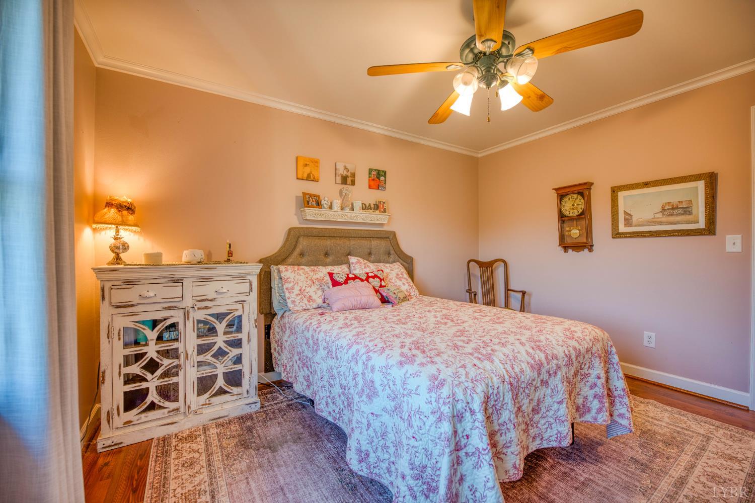 2287 Johnson Creek Road Evington, VA 24550 - Photo 20 of 70 a bedroom with a bed and a chandelier