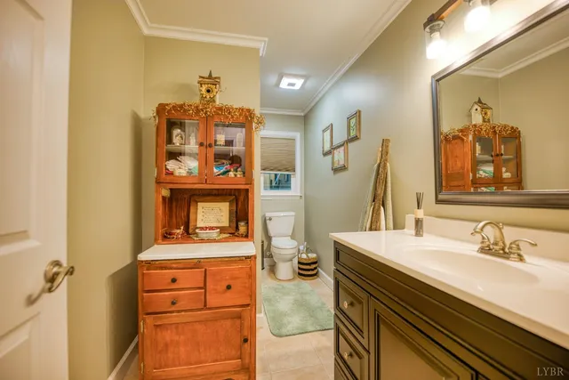 a view of a hallway with wooden floor fireplace and living room